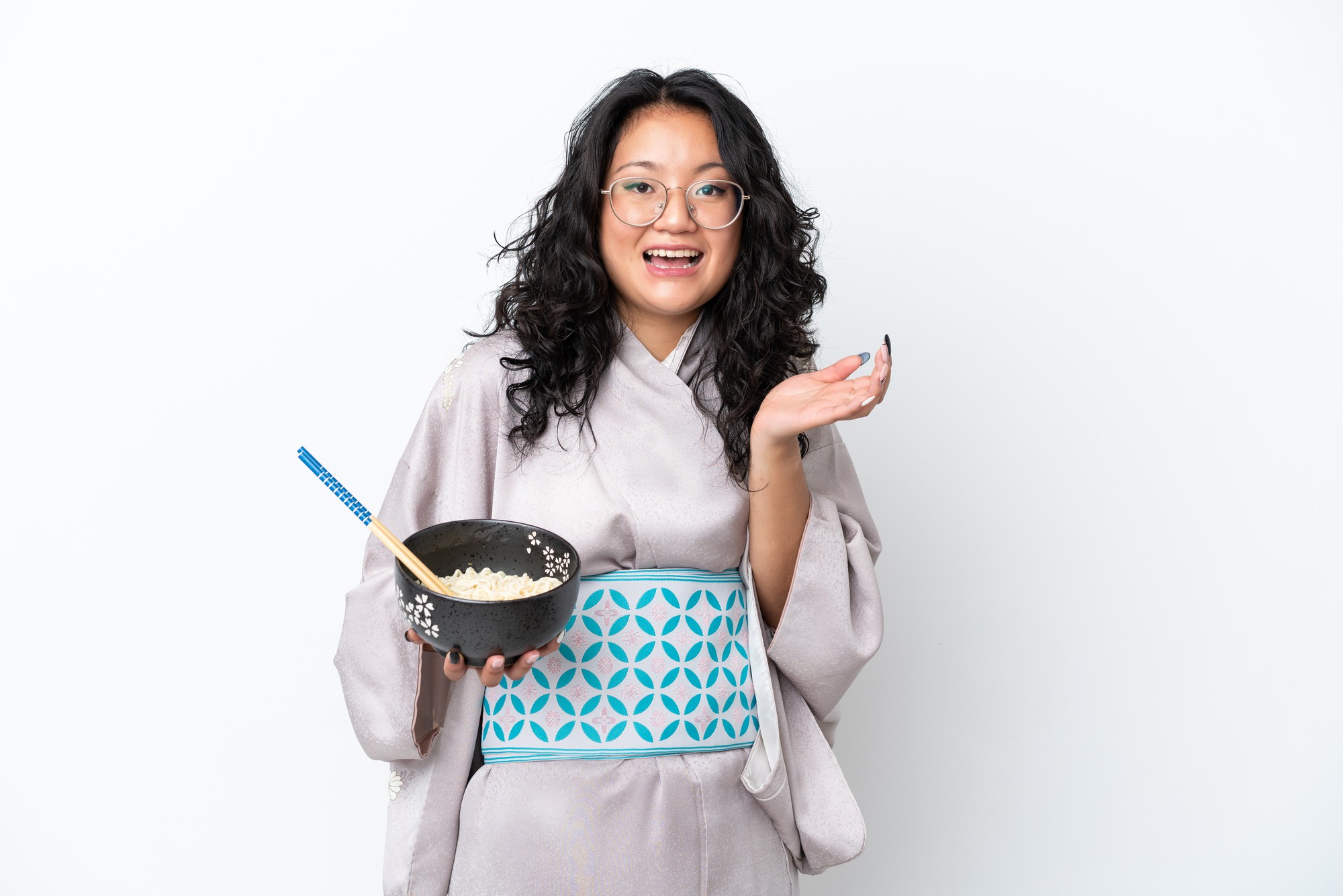 Student plating a composed bowl in a communal kitchen